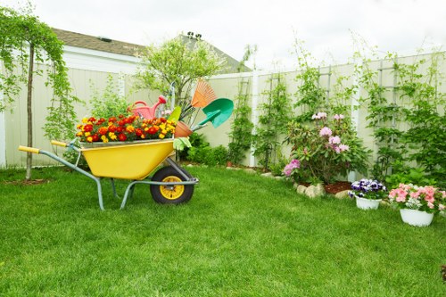 Operatives carrying out hedge cutting with safety barriers